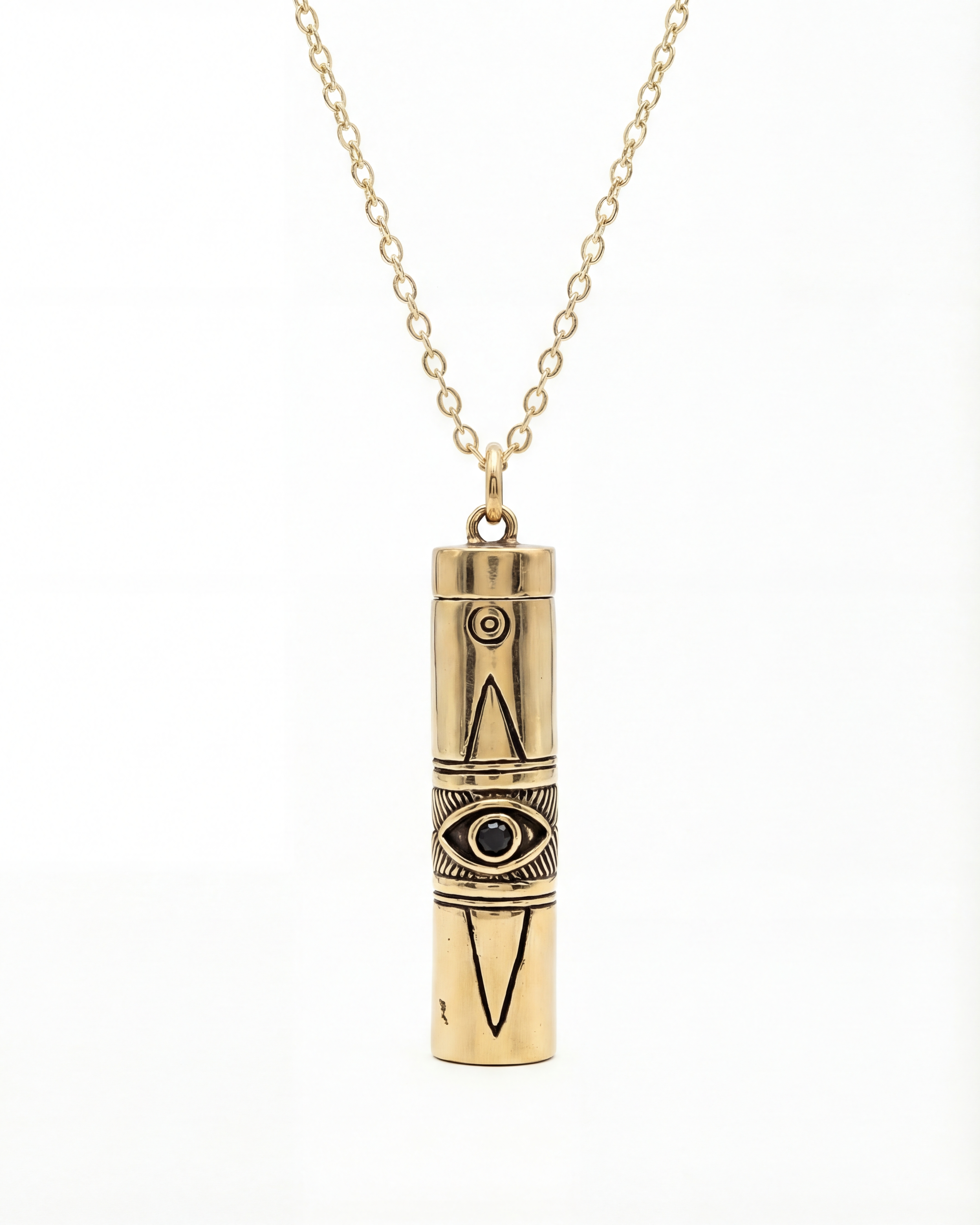 Gold cylindrical pendant necklace with eye design on a white background
