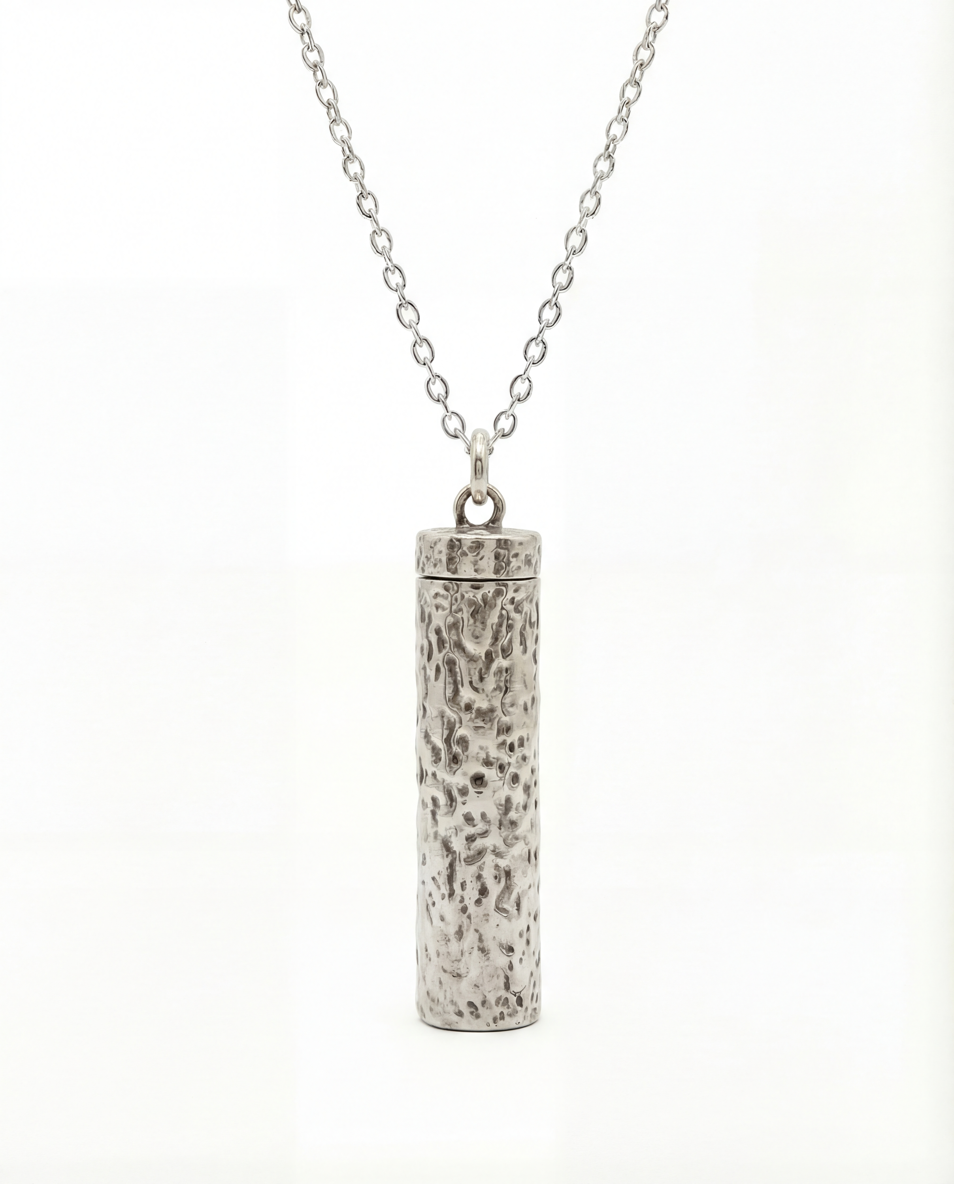Silver cylindrical pendant on a chain against a white background