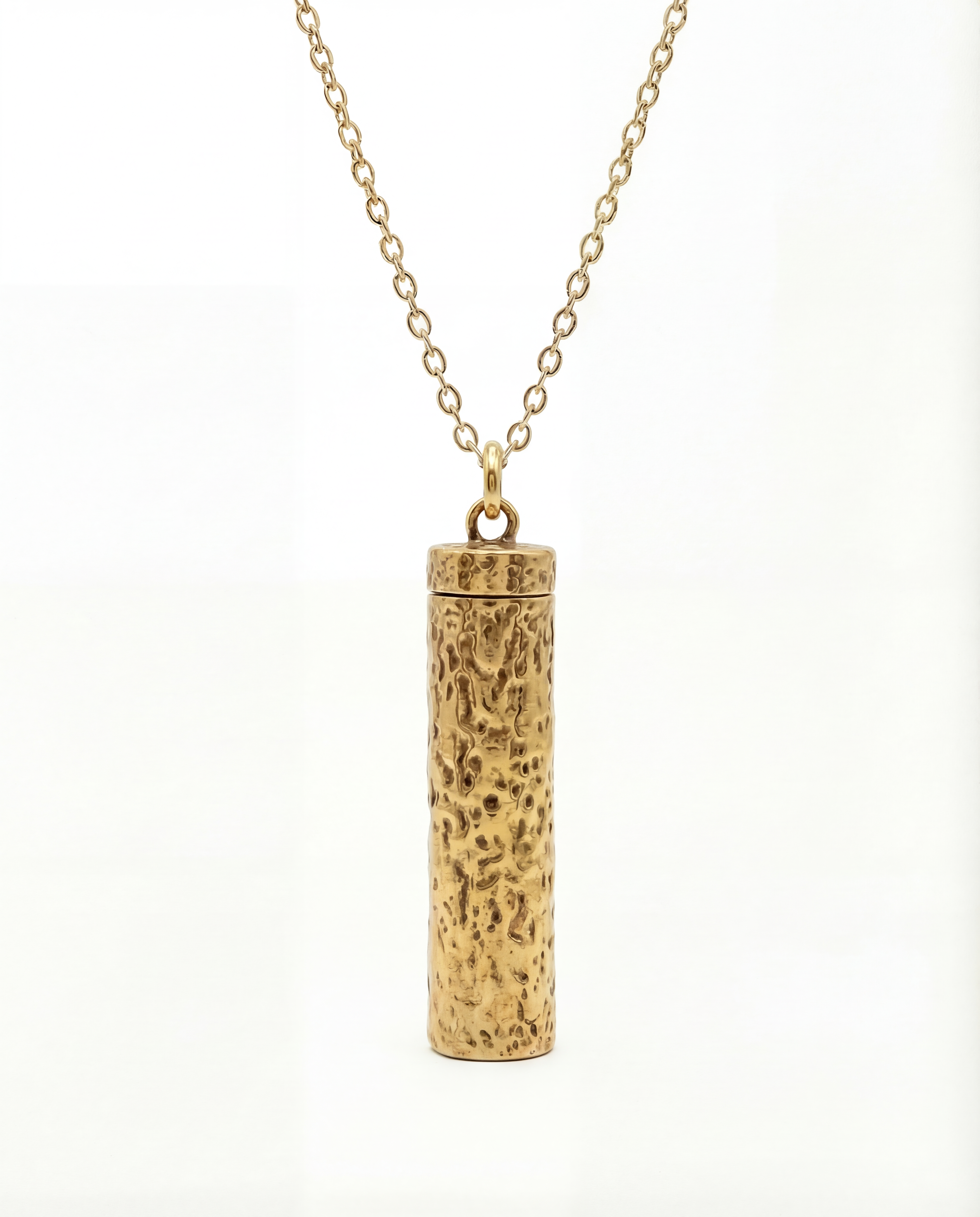 Gold cylindrical pendant necklace on a white background