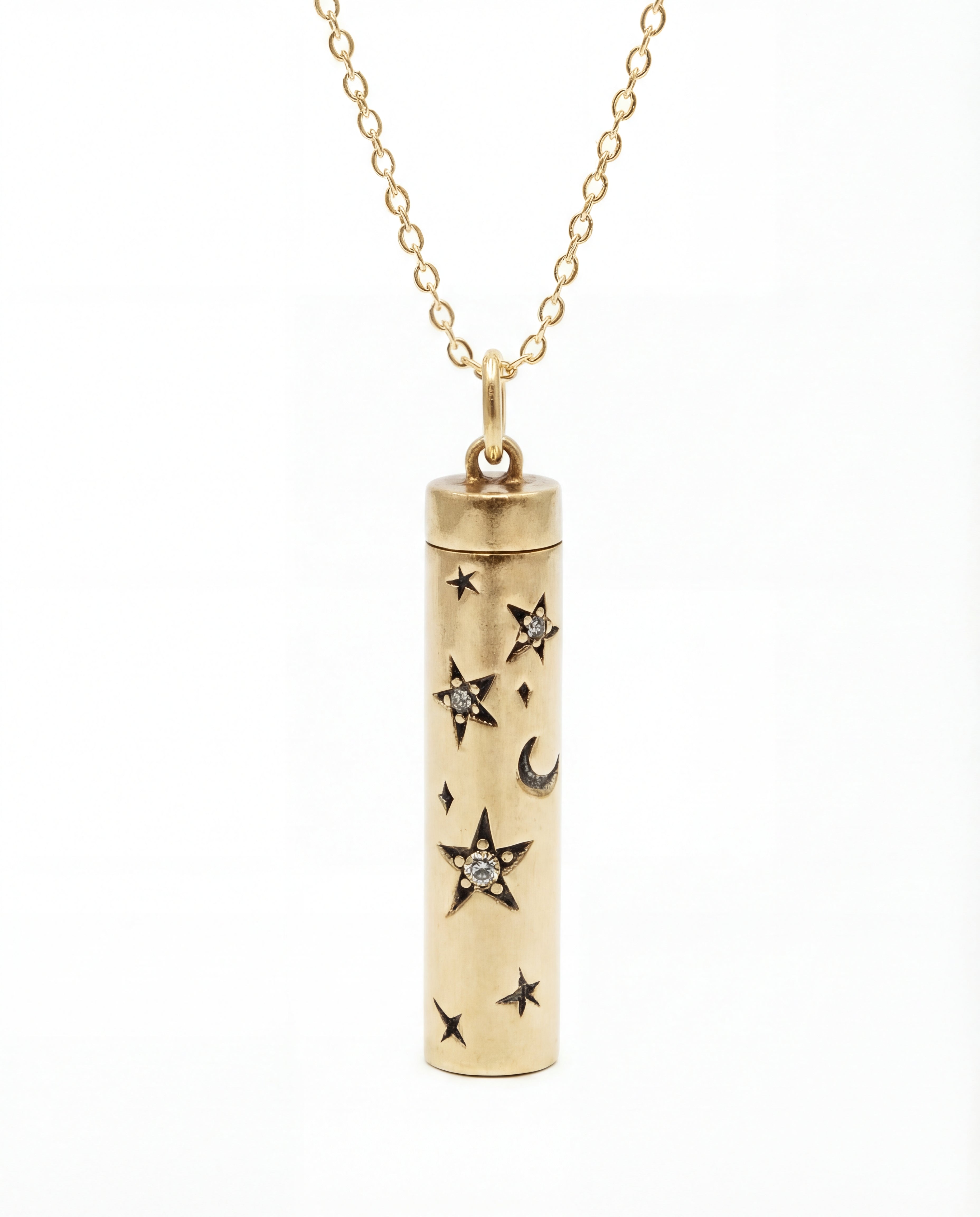 Gold cylindrical pendant with star and moon designs on a white background